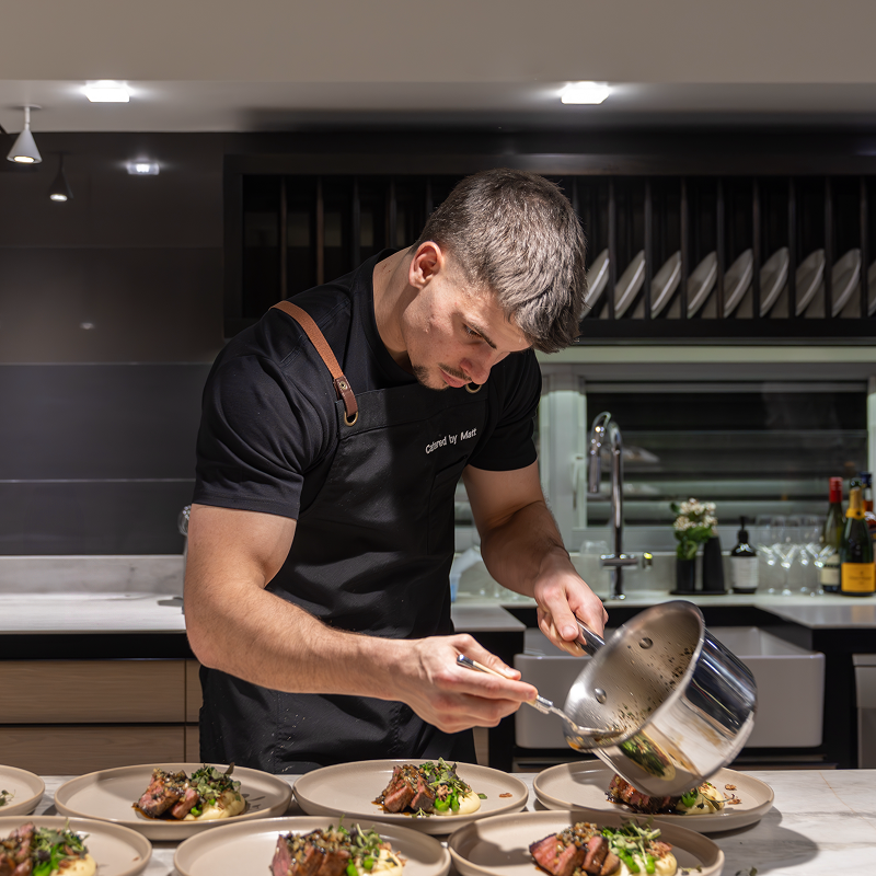 Chef Matt preparing meals in kitchen for 80-guest private event