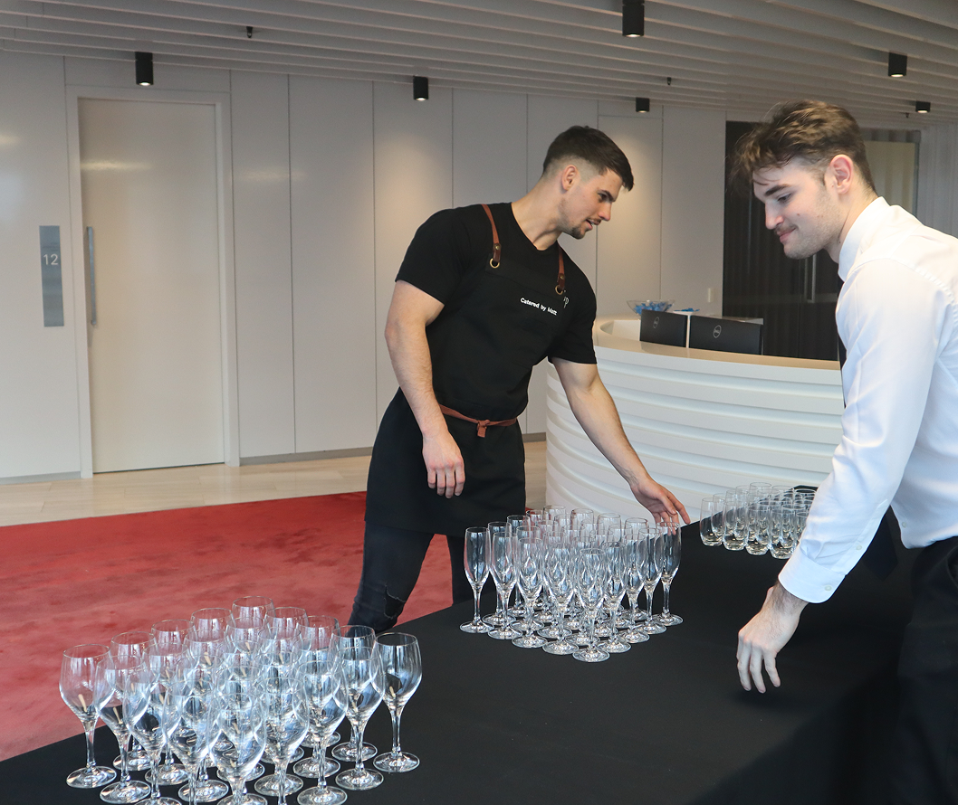 Conference catering team setting up champagne