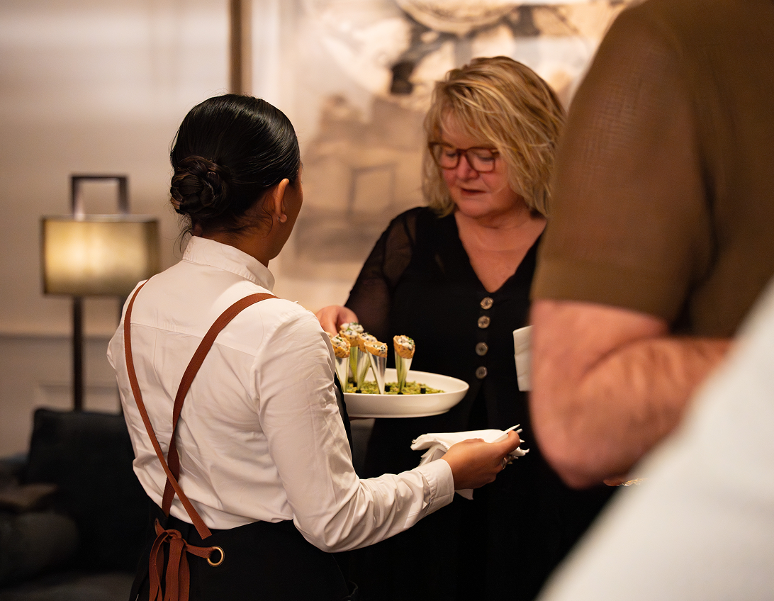 Waiter serving elegant savoury canapés at North Ryde business event