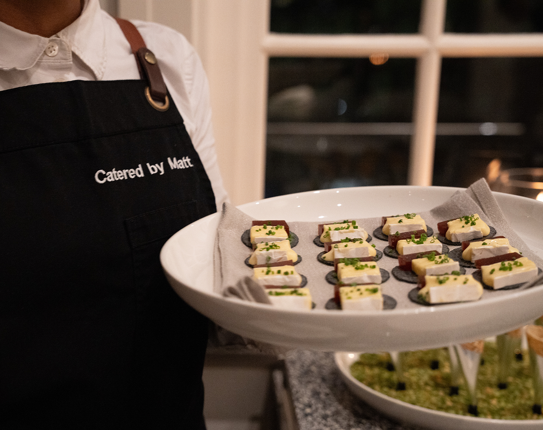 Waiter presenting premium canapés to North Shore party guests