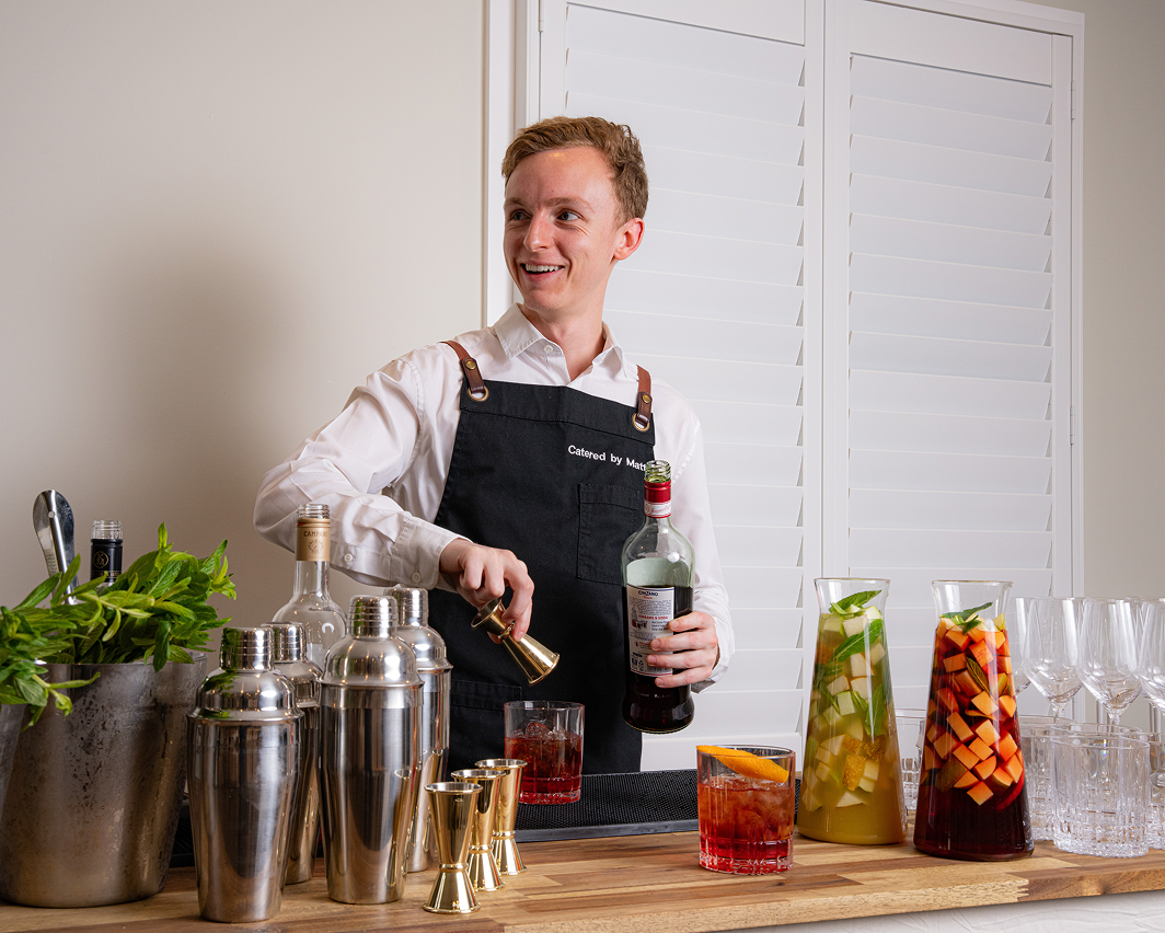 Waiter preparing premium cocktail jugs for private chef Sydney catering guests