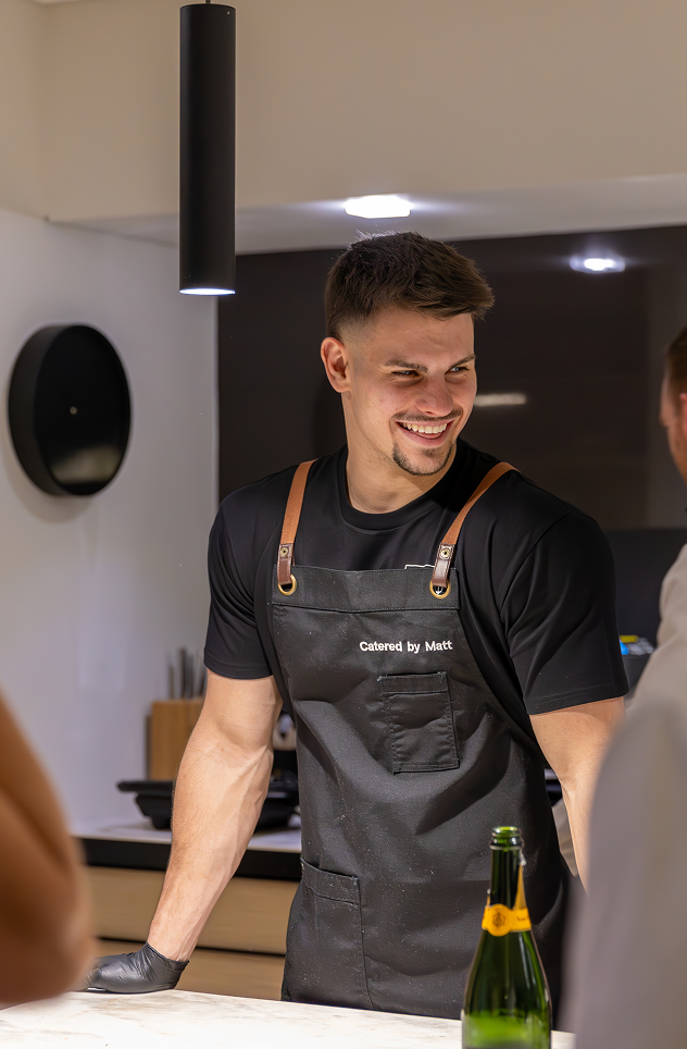 Chef Matt smiling with guests at Woollahra catering event