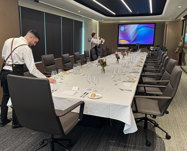 CBM team prepping boardroom table for executive catering event Sydney
