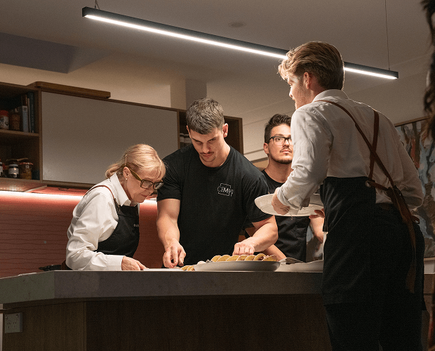 Chef Matt preparing a corporate catering Sydney meal with team