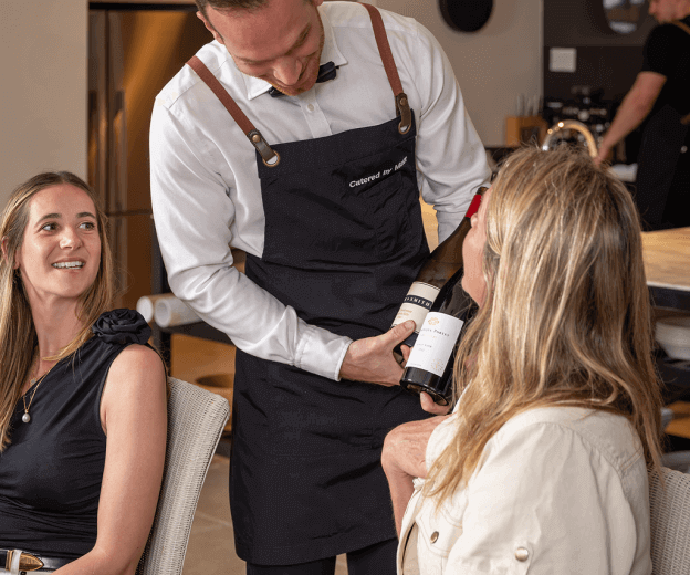 Waiter displaying wine selection at Sydney team building catering
