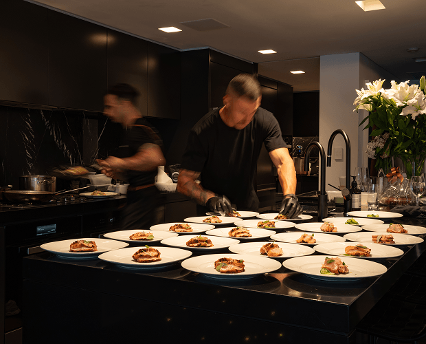 Chef George blurred in motion serving degustation at a Sydney home party