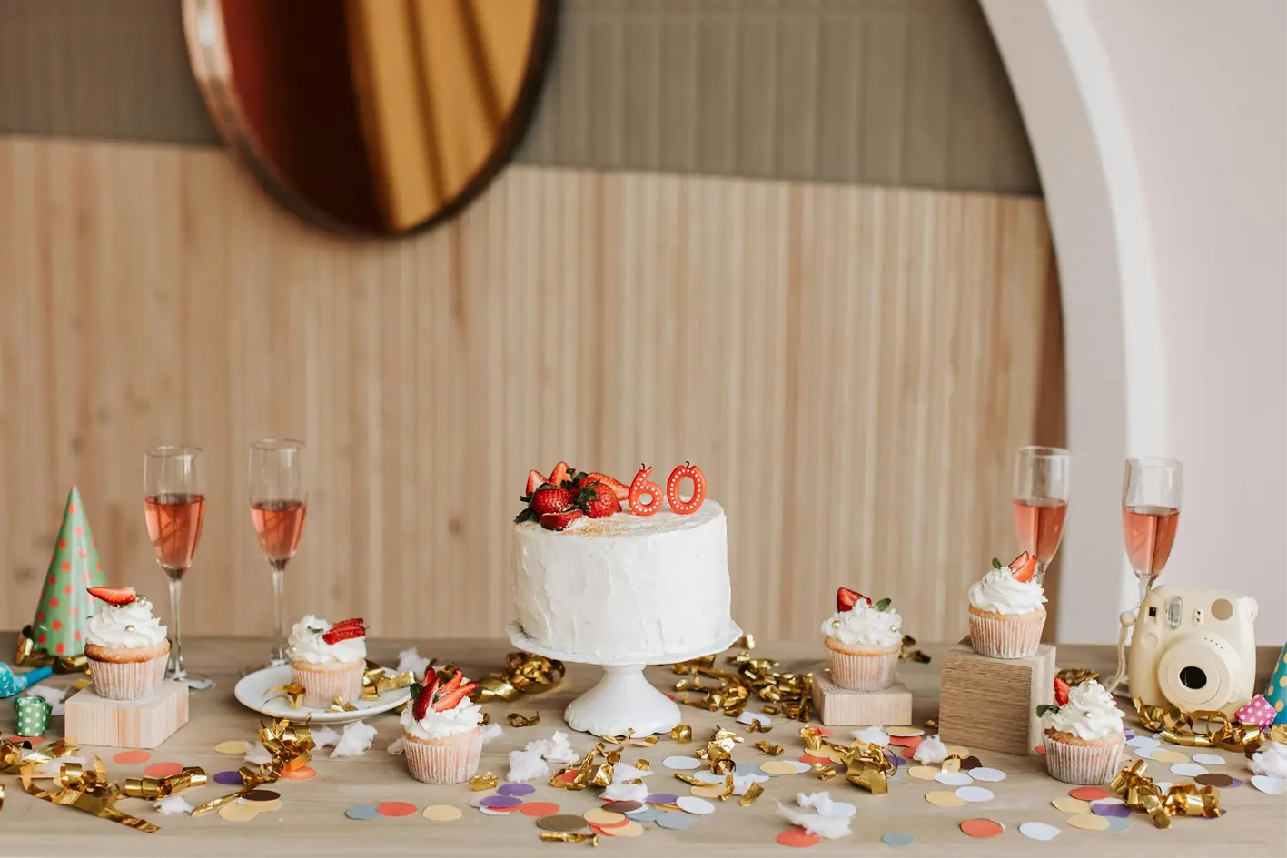 60th birthday cake with candles on a table at a celebration
