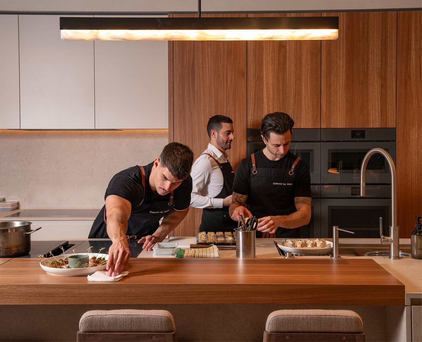 Private chefs preparing canapés in a home kitchen for a relaxed 60th birthday at home
