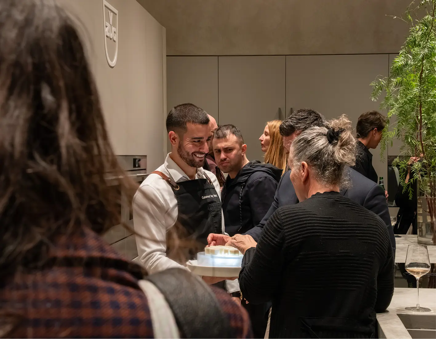 Waiter serving canapés to guests at a Sydney corporate event for 80 people