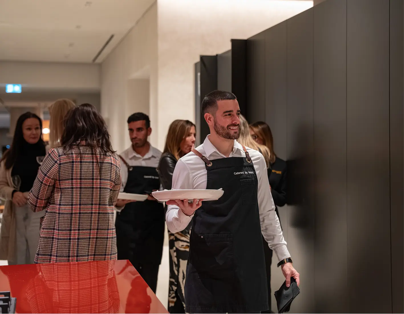 Waitstaff circulating with canapés among a team at a corporate team building event