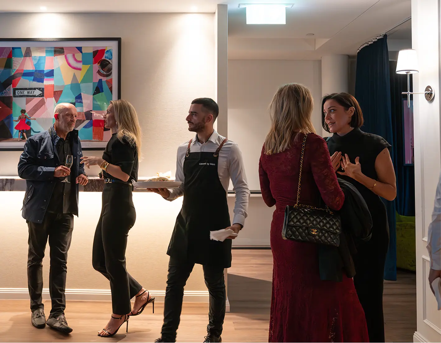 Waiter offering canapés to guests at a fully managed Mosman catering event