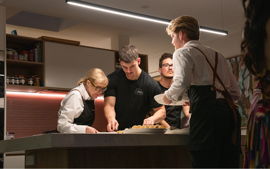 Catering team preparing food for an event with a clear checklist