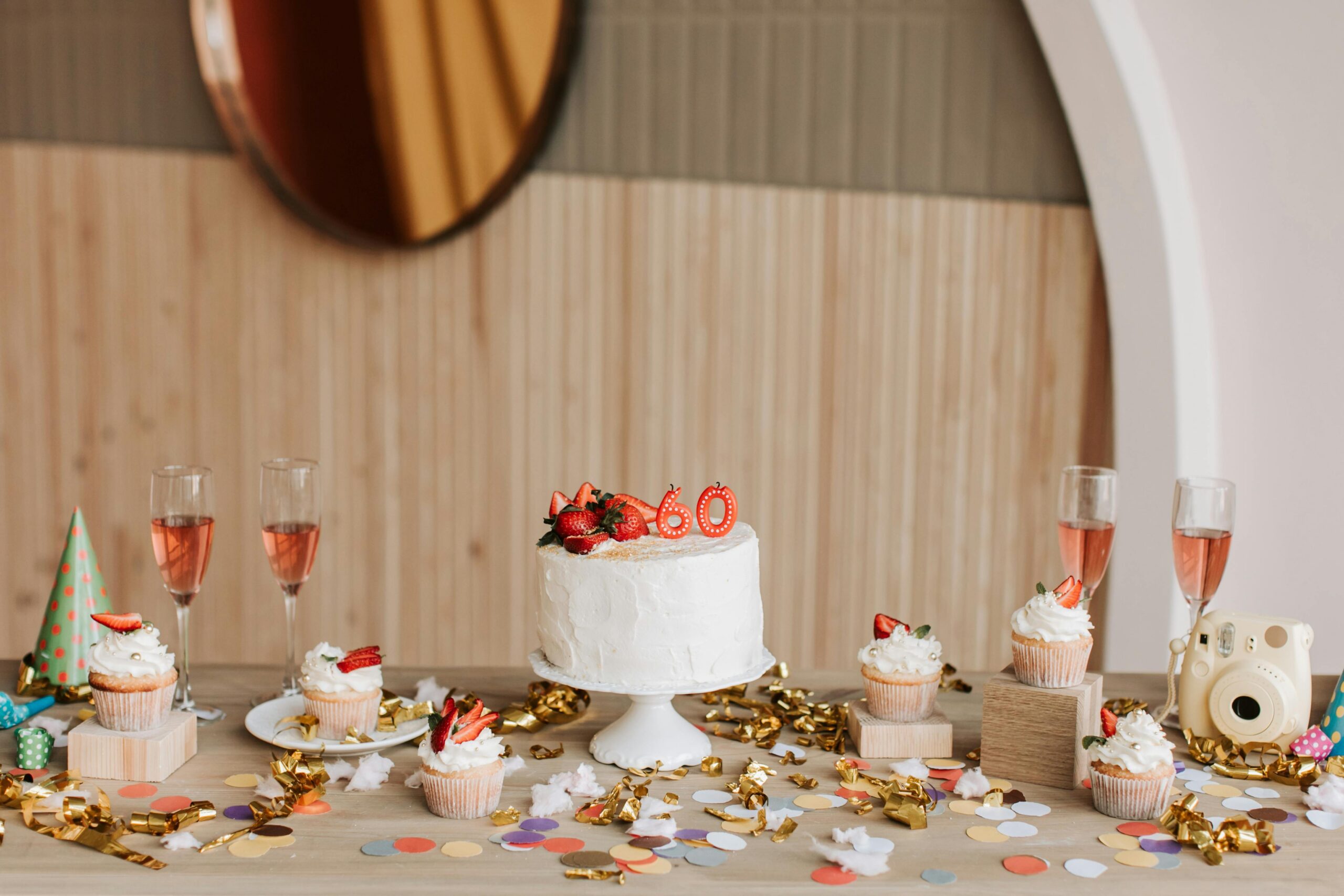 60th birthday cake with candles on a table at a celebration