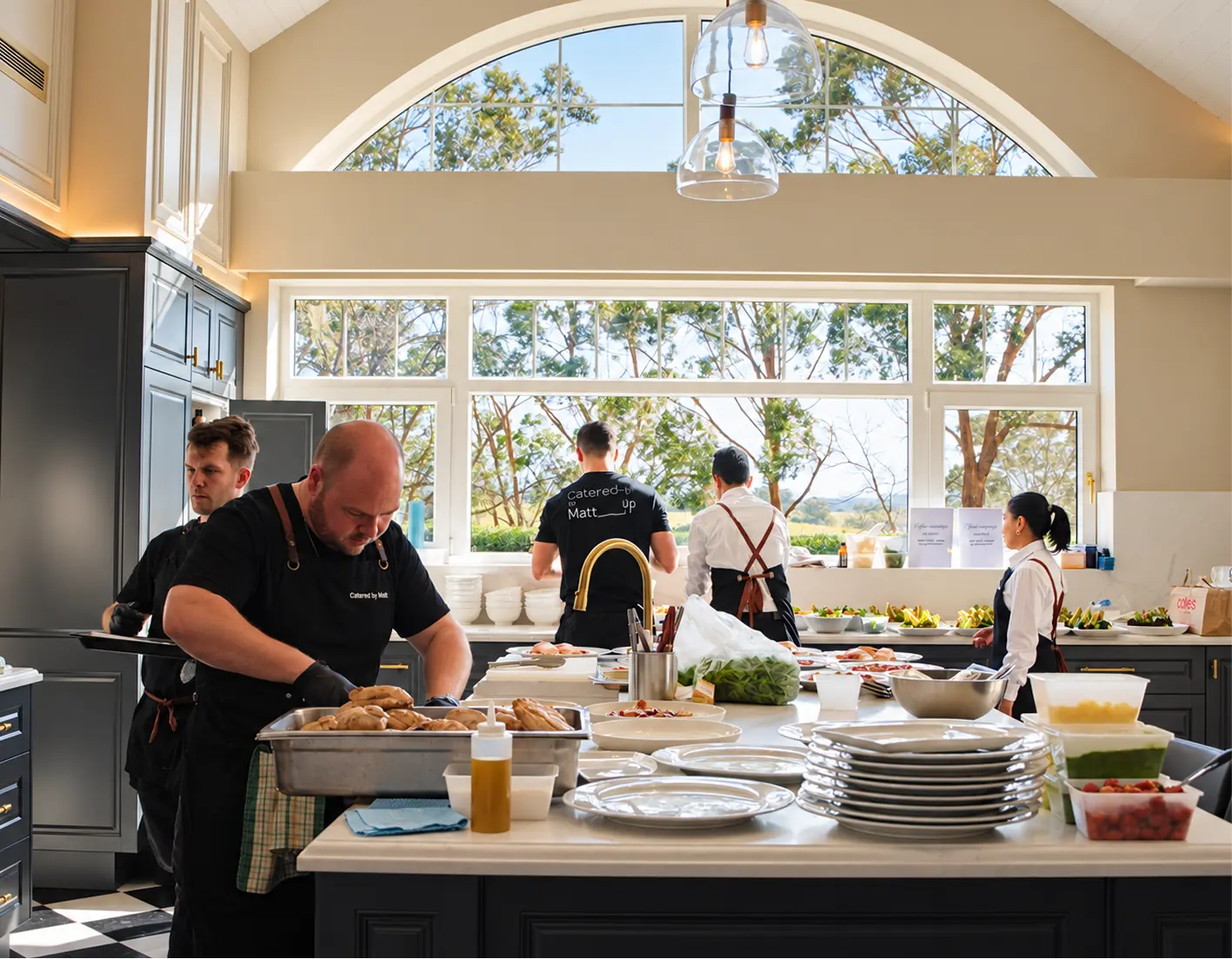 Catering team working a country house kitchen through service for a Sydney event