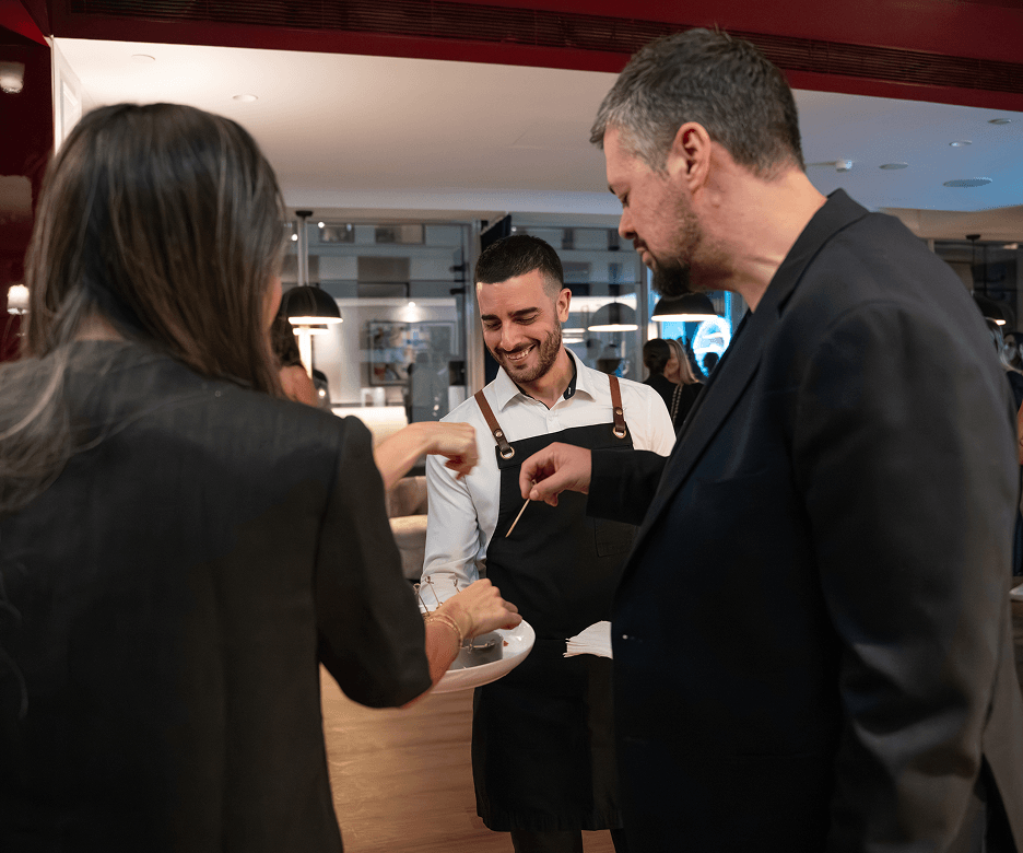 Corporate catering Sydney guests enjoying canapés served by event staff at a business function