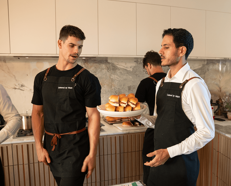 Cocktail party catering Sydney staff serving gourmet slider canapés to guests