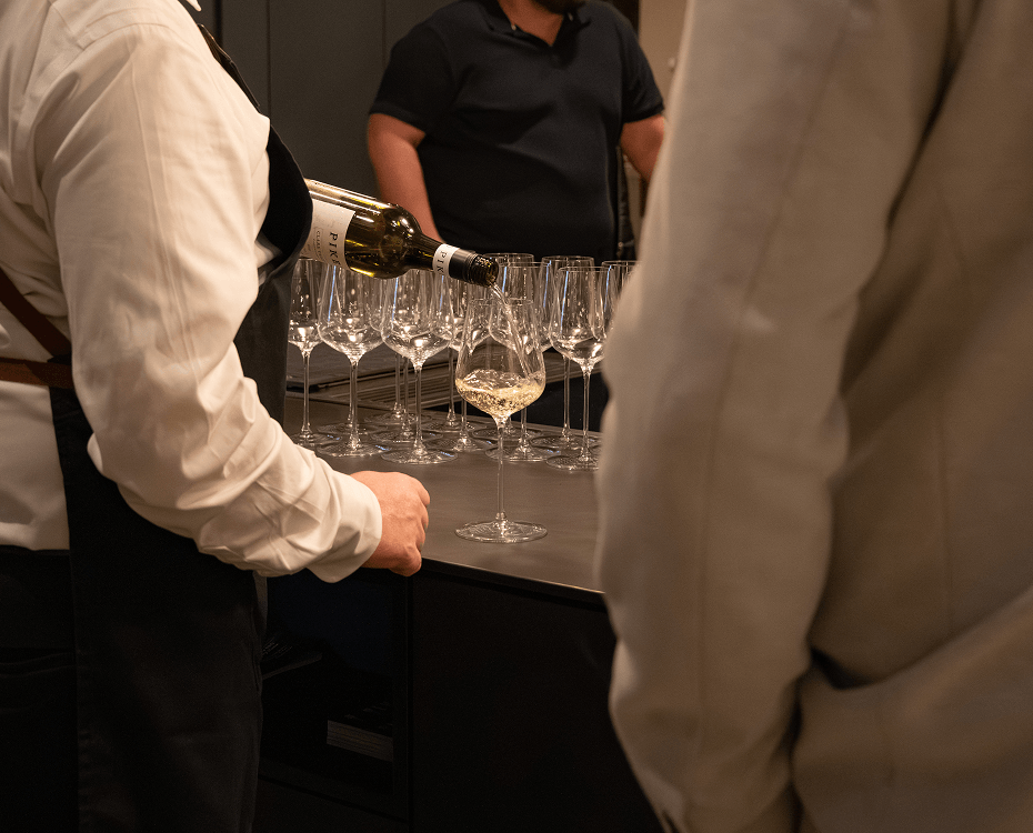 Guests enjoying wine and conversation at a 60th birthday celebration