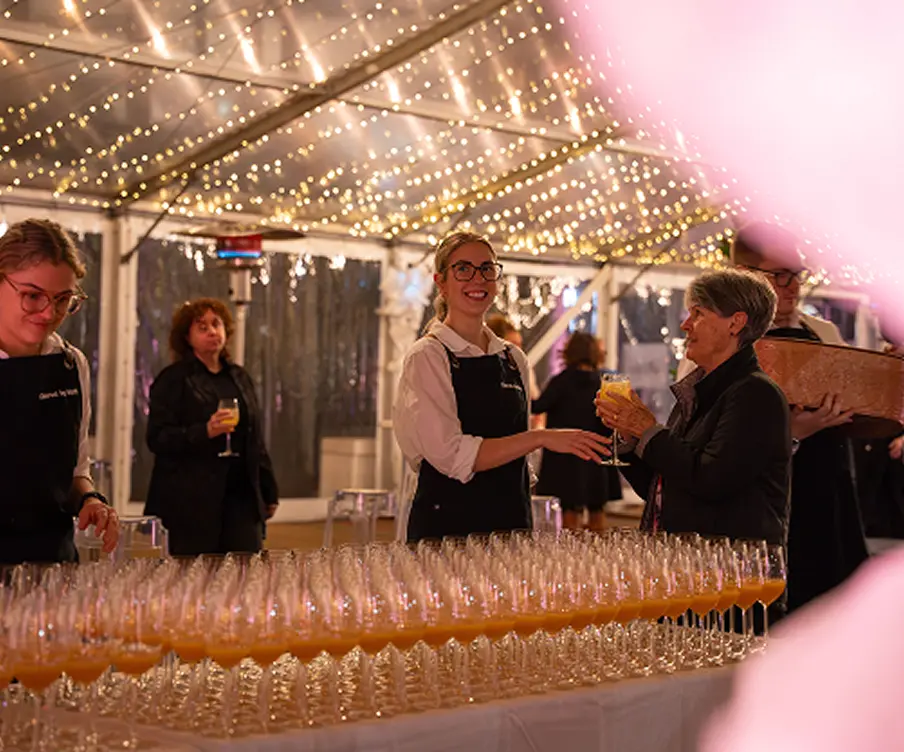 Staff serving drinks under fairy lights at a Penrith marquee event