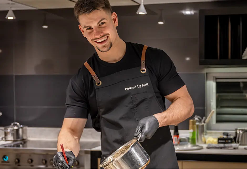Chef Matthew Mirosevich finishing a dish in the kitchen at a Western Sydney event