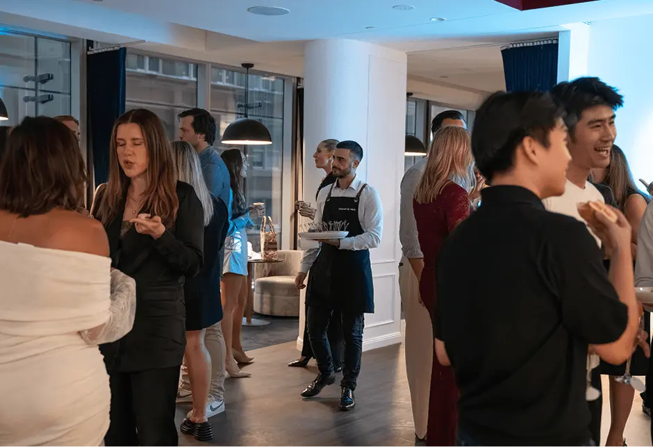 Guests mingling over canapés at a North Sydney apartment party