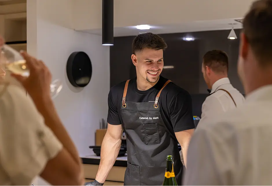 Chef Matt opening sparkling wine for guests at an Inner West home celebration