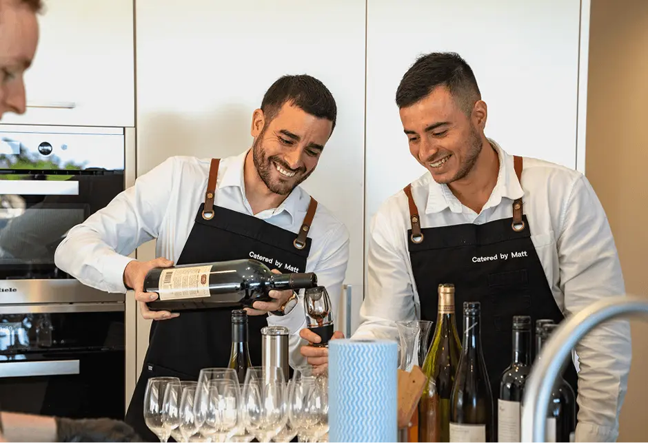Catered by Matt staff opening wine and setting up glassware for a Surry Hills event