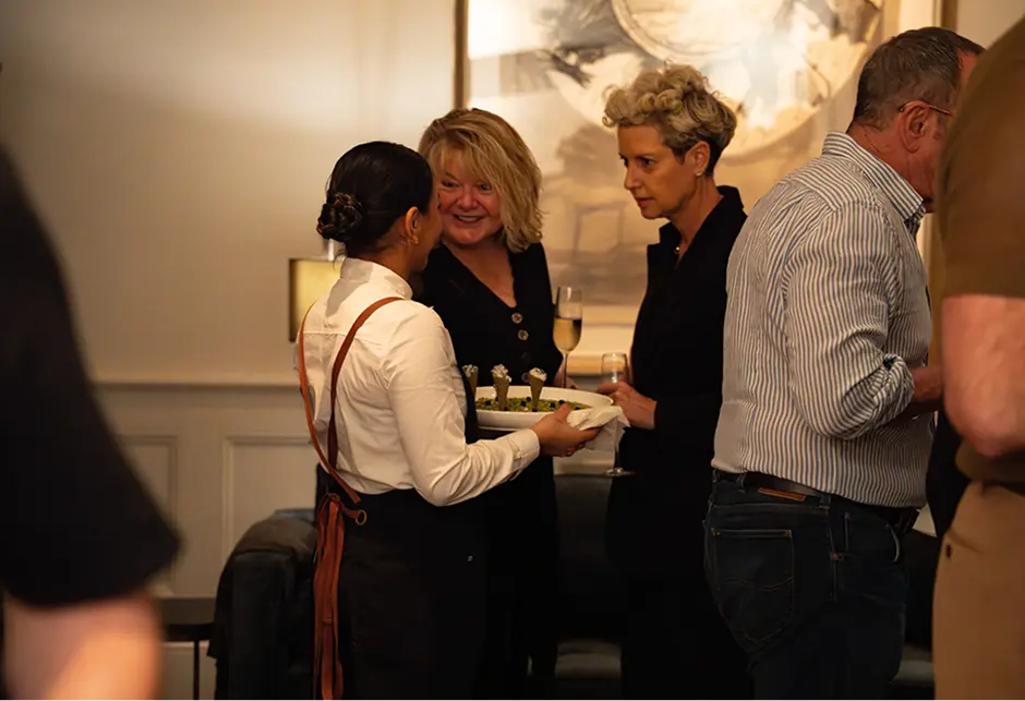 Waitstaff offering canapés to guests at a Sydney CBD function