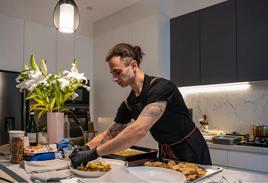 Chef Vinnie plating canapés in a Mosman home kitchen before guests arrive
