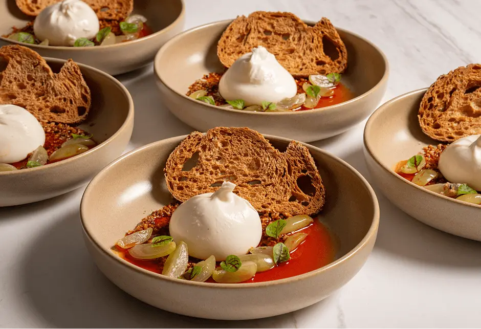 Bowls of tomato, burrata and toasted sourdough plated for a Surry Hills dinner