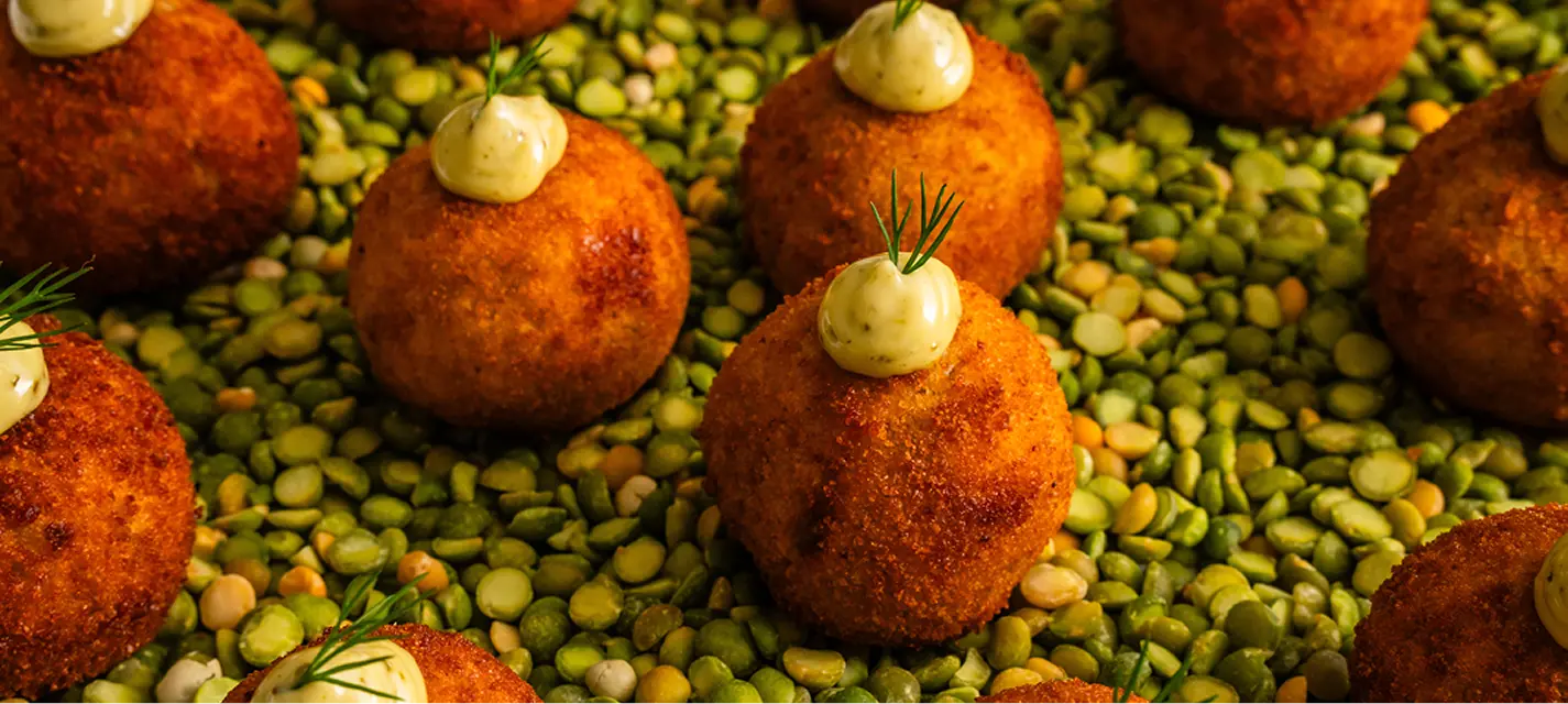 Croquette canapés with aioli and dill served on green peas at a Parramatta event