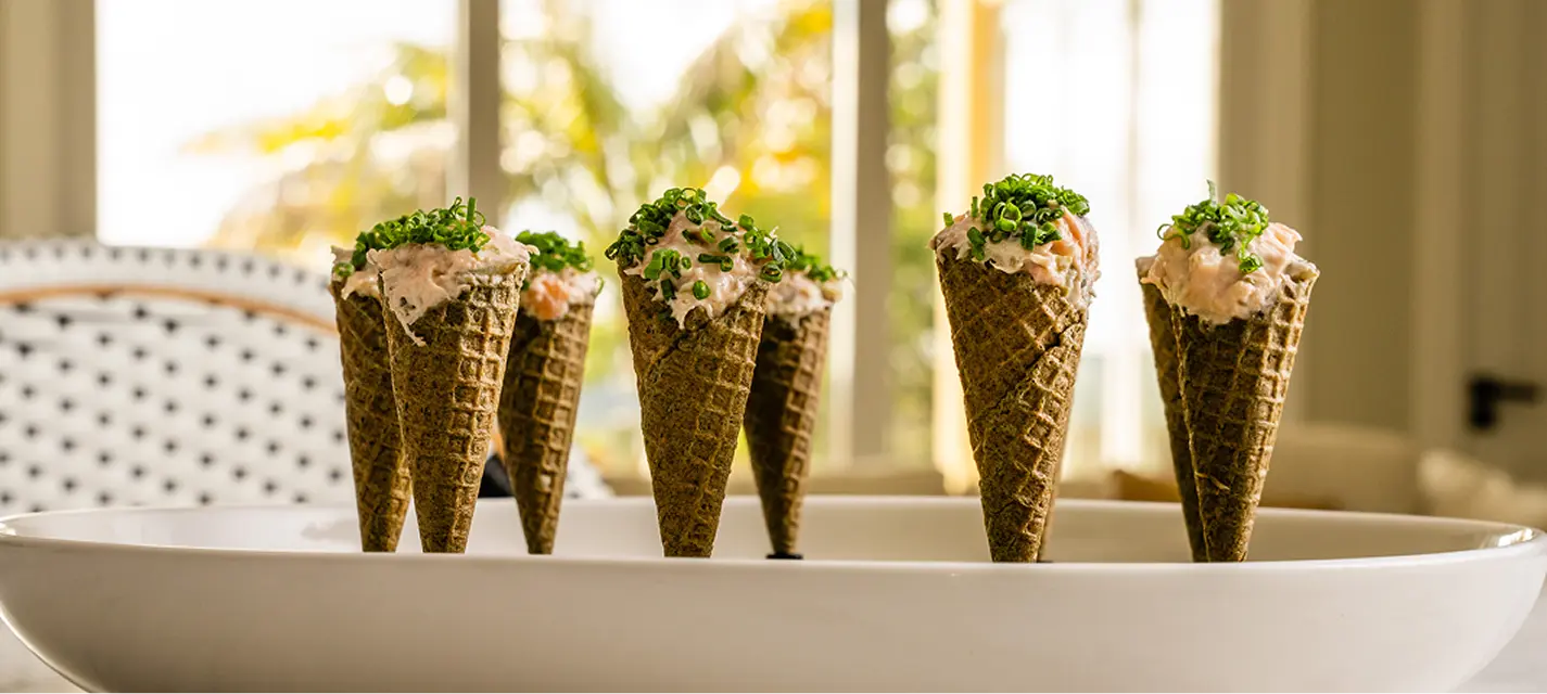 Herb cones filled with crab remoulade standing in a dish at a Surry Hills event