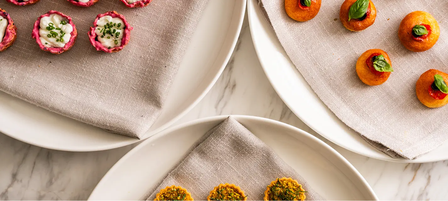 Trays of beetroot cups, tomato bites and tartlets for a Western Sydney event