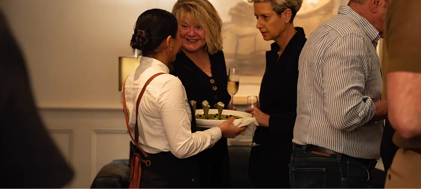 Waitstaff offering canapés to guests at a Northern Beaches event