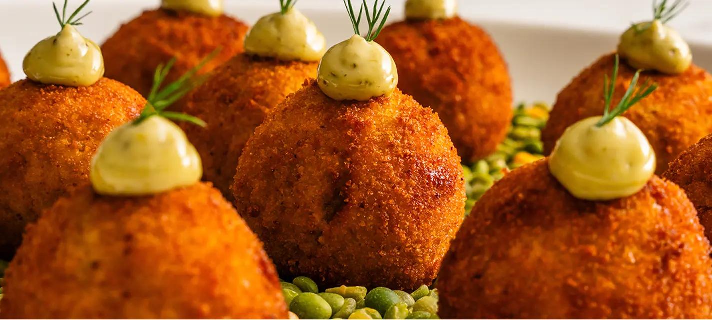 Croquette canapés with aioli and dill served on green peas at an Eastern Suburbs event