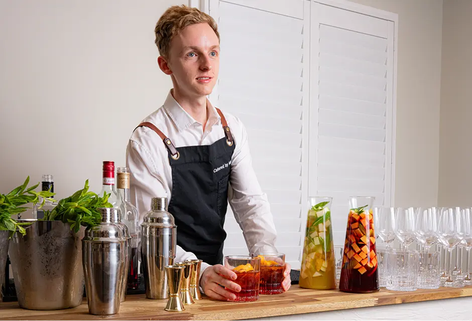 Bar staff mixing cocktails at a home bar setup for a Chatswood event