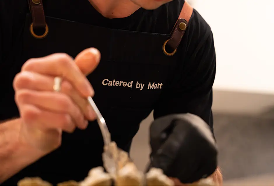 Close up of a Catered by Matt chef spooning a garnish onto a canapé at a Surry Hills event