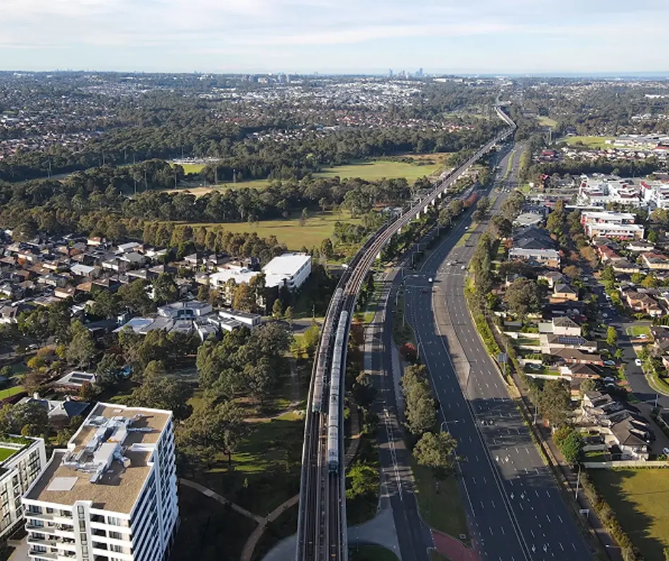 Aerial view over the suburbs and rail corridor of Western Sydney