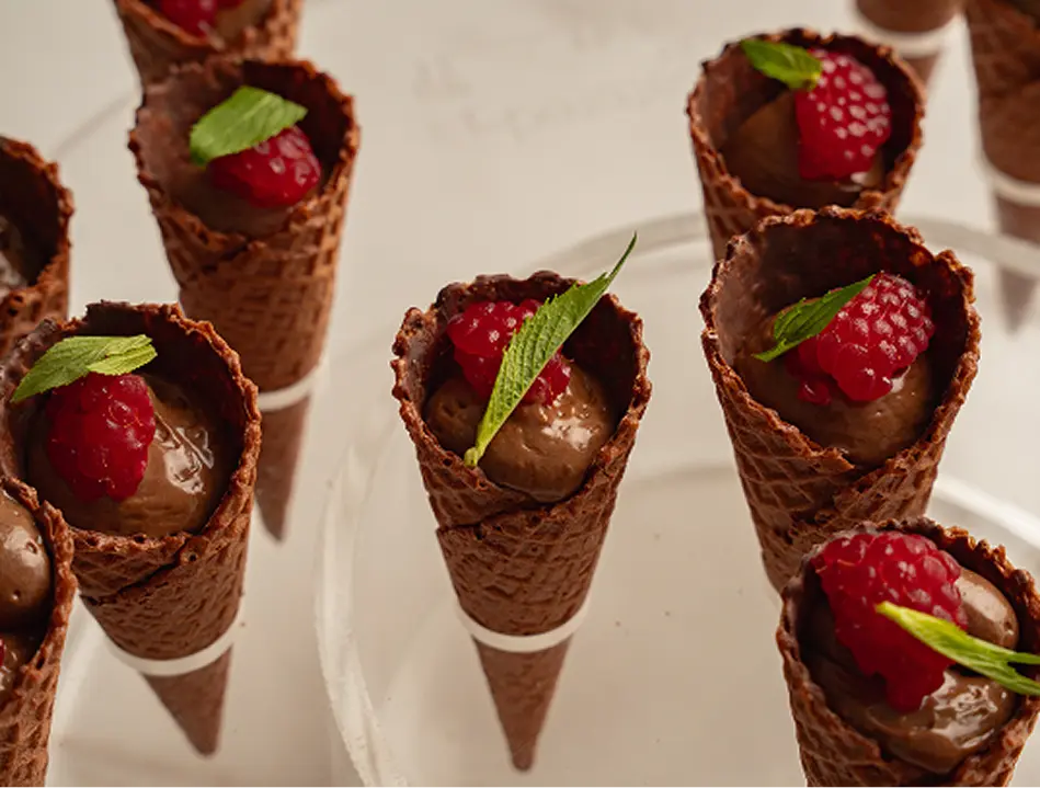 Chocolate mousse cones topped with raspberry at a Parramatta event