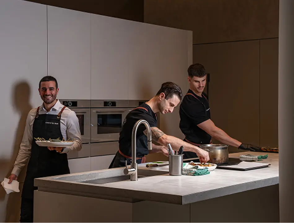 Catering team plating and serving from a North Shore home kitchen