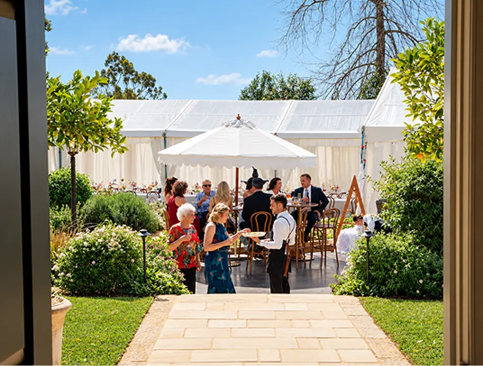 Catering staff serving guests at an outdoor Northern Beaches celebration