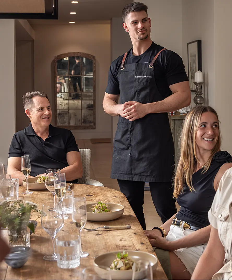 Chef talking with guests at a long table dinner in Surry Hills