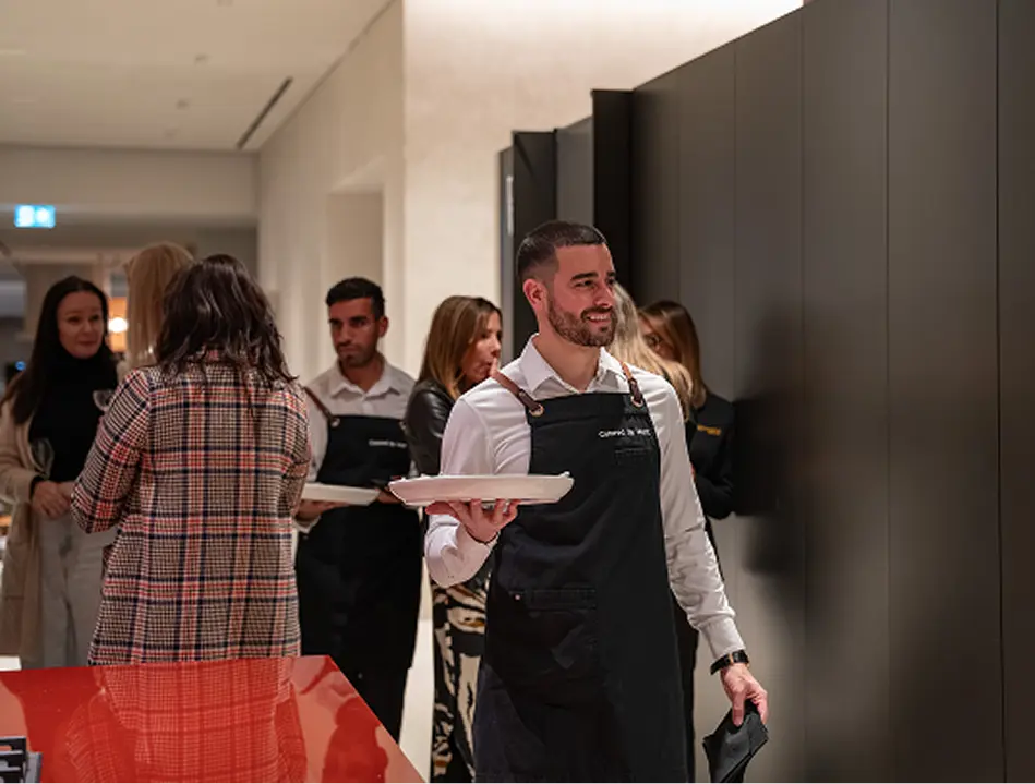 Waiter moving through guests with canapés at a Parramatta event