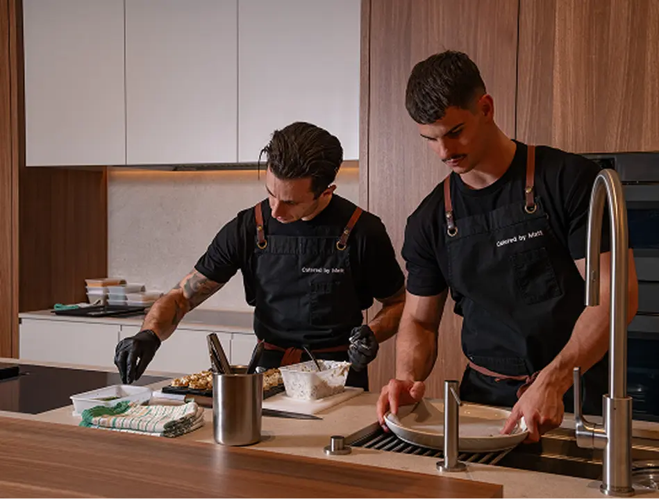 Chefs preparing canapés in a Castle Hill kitchen for a fully managed event