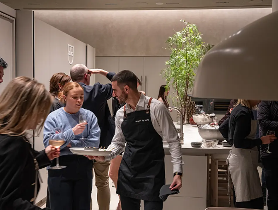 Waiter offering canapés while guests socialise at a North Sydney event