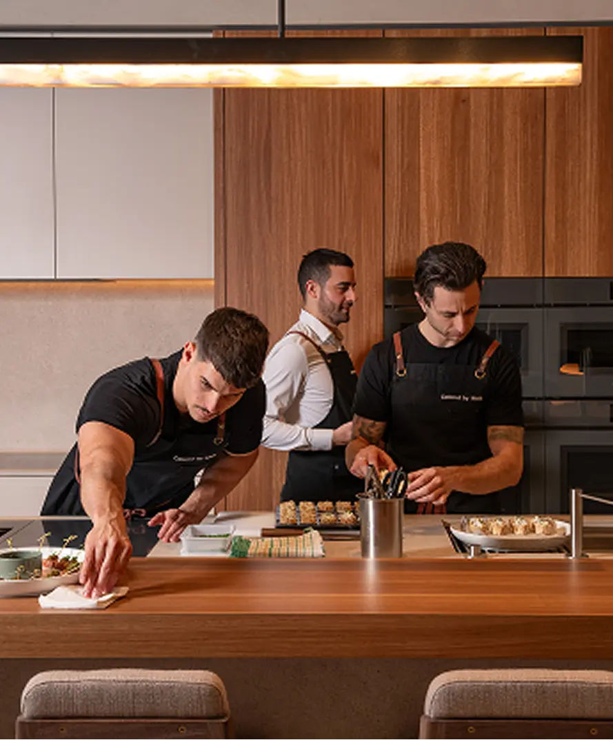 Catered by Matt chef team plating dishes together, the crew behind party catering across Sydney