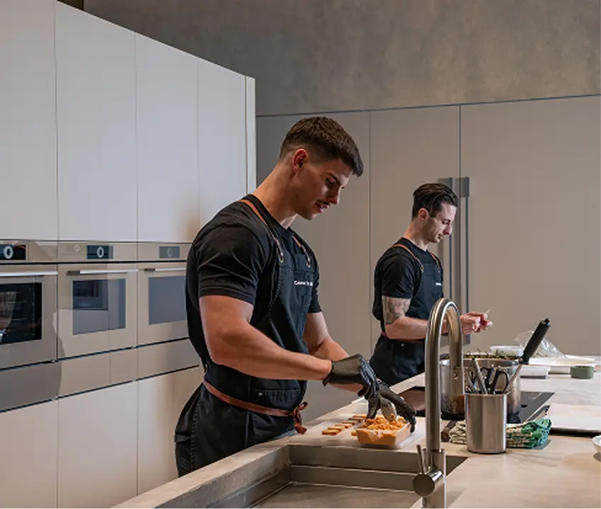 Chefs Matt and Vinnie preparing canapés in a kitchen ahead of a Sydney funeral reception