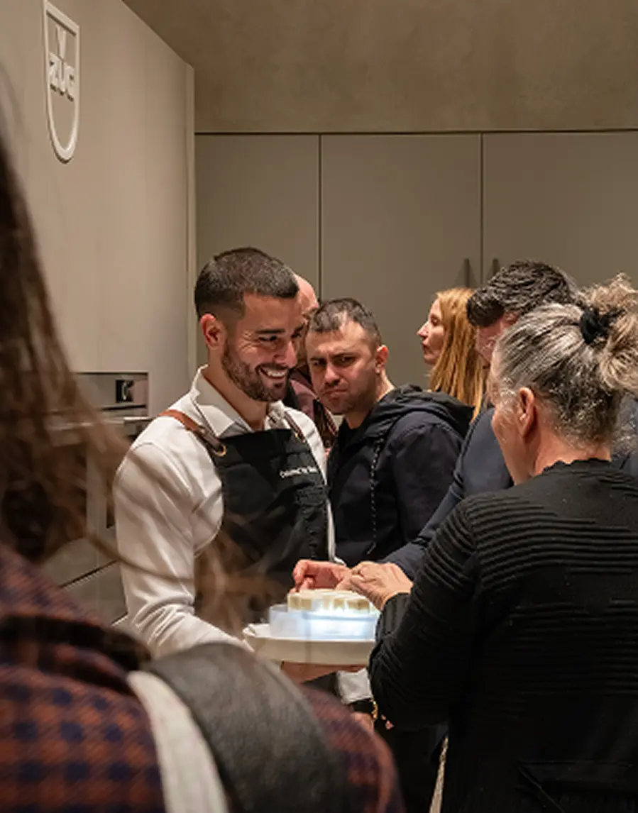 Waiter offering canapés to guests at a Chatswood office event