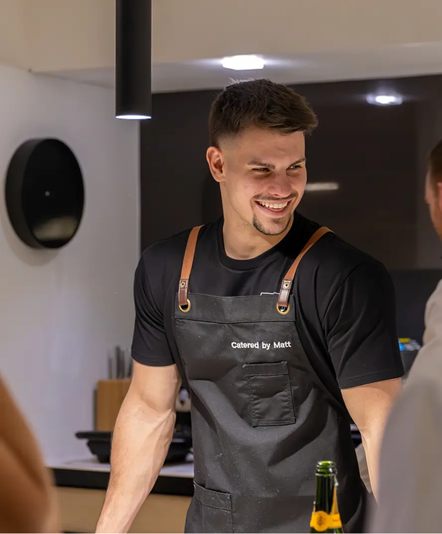 Chef Matt hosting guests over drinks in an Eastern Suburbs kitchen