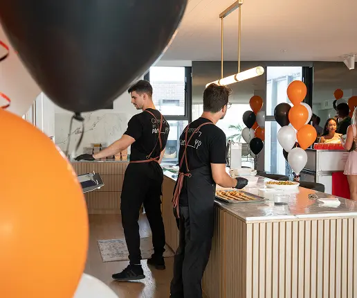 Catering team running service beside balloons at a large party in Sydney