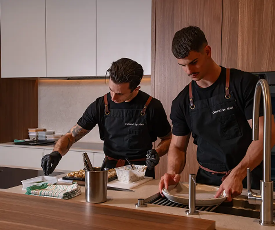 Chefs Vinnie and Matt preparing a private dinner in a Campbelltown home kitchen